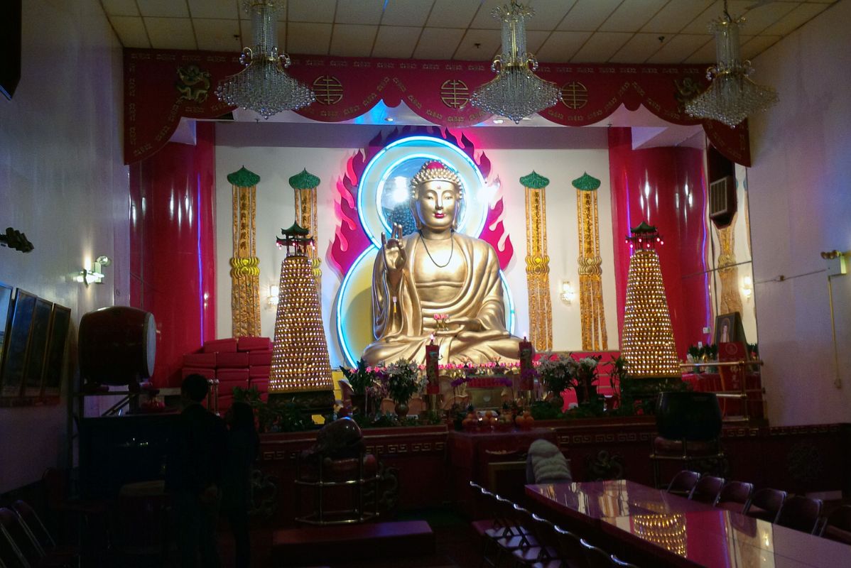 13-3 A Large 5m Tall Buddha Sits Atop A Giant Lotus flower With An Ethereal Blue Halo Around Its Head In Mahayana Buddhist Temple At 133 Canal St In Chinatown New York City